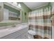 Bathroom with shower/tub, vanity, and striped shower curtain at 120 Georgetown Dr, Casselberry, FL 32707