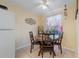 Cozy dining area with a round table and four chairs, situated near a window at 120 Georgetown Dr, Casselberry, FL 32707