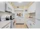 Bright kitchen featuring white cabinets, updated countertops, and modern appliances at 120 Georgetown Dr, Casselberry, FL 32707