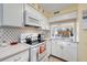 Bright kitchen featuring white cabinets, updated countertops, and modern appliances at 120 Georgetown Dr, Casselberry, FL 32707