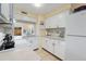 Bright kitchen featuring white cabinets, updated countertops, and modern appliances at 120 Georgetown Dr, Casselberry, FL 32707