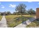 Green lawn with walkway and trees at 120 Georgetown Dr, Casselberry, FL 32707