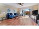 Spacious living room with hardwood floors, a ceiling fan and access to a patio at 120 Georgetown Dr, Casselberry, FL 32707