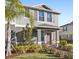 Two-story house with gray siding, brown shutters, and a landscaped front yard at 13311 Pontoon Rd, Winter Garden, FL 34787