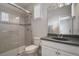 Updated bathroom with walk-in shower and gray tile at 13871 Briand Ave, Orlando, FL 32827