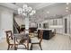 Bright dining area with a glass-top table and kitchen view at 13871 Briand Ave, Orlando, FL 32827