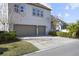 Two-car garage with neutral-toned doors and manicured landscaping at 13871 Briand Ave, Orlando, FL 32827