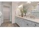 Double vanity bathroom with granite countertop and walk-in shower at 15813 Gem View St, Winter Garden, FL 34787