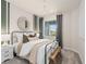 Cozy bedroom with metal bed frame and window at 15813 Gem View St, Winter Garden, FL 34787