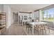Open concept dining area with white table and chairs and view of the kitchen at 15813 Gem View St, Winter Garden, FL 34787