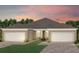 Two-story house with a two-car garage and landscaped yard at 15813 Gem View St, Winter Garden, FL 34787