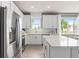 White kitchen with stainless steel appliances and quartz countertops at 15813 Gem View St, Winter Garden, FL 34787