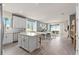 Open concept kitchen with white cabinets, island, and stainless steel appliances at 15813 Gem View St, Winter Garden, FL 34787