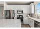Spacious kitchen with white cabinets, quartz countertops, and stainless steel appliances at 15813 Gem View St, Winter Garden, FL 34787