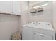 Laundry room with washer, dryer, and overhead shelving at 15813 Gem View St, Winter Garden, FL 34787