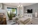 Living room with comfortable seating, large TV, and access to backyard at 15813 Gem View St, Winter Garden, FL 34787