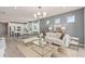 Open living room and kitchen with modern design and neutral color palette at 15813 Gem View St, Winter Garden, FL 34787