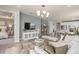 Open concept living room with neutral decor and view of the kitchen and bedroom at 15813 Gem View St, Winter Garden, FL 34787