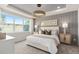 Spacious main bedroom with large window, plush bed, and wood-look floors at 15813 Gem View St, Winter Garden, FL 34787
