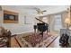 Living room featuring a grand piano, tasteful rug, and hardwood floors at 1593 Compass Ct, Kissimmee, FL 34744