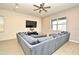 Spacious living room with a large sectional sofa and a mounted TV at 15959 Pantuso Aly, Winter Garden, FL 34787