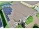 Aerial view of home featuring installed solar panels and screened-in pool at 1855 Sugar Cove Ct, Ocoee, FL 34761
