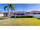 Large backyard with well-maintained lawn, shrubbery, and a screened-in pool area at 1855 Sugar Cove Ct, Ocoee, FL 34761