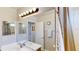 Bathroom featuring double sinks, a large mirror with lighting, a shower, and a separate toilet room at 1855 Sugar Cove Ct, Ocoee, FL 34761