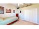 Well-lit bedroom with a bed, closet, and trophies on display at 1855 Sugar Cove Ct, Ocoee, FL 34761