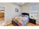Well-lit bedroom featuring wood-look flooring, closet, and a comfortable queen-size bed at 1855 Sugar Cove Ct, Ocoee, FL 34761