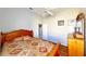 Cozy bedroom with a patterned quilt, wood floors, a ceiling fan, and closet access at 1855 Sugar Cove Ct, Ocoee, FL 34761