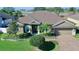 Well-maintained home with landscaping, a paver driveway, and a neutral color scheme at 1855 Sugar Cove Ct, Ocoee, FL 34761
