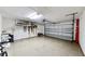 Spacious two-car garage with epoxy flooring and overhead storage racks, ready for your projects at 1855 Sugar Cove Ct, Ocoee, FL 34761