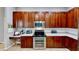Kitchen with stainless steel appliances, white countertops, and dark wood cabinets at 1855 Sugar Cove Ct, Ocoee, FL 34761