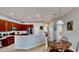 Kitchen area featuring counter seating, tile floors, and dark wood cabinetry at 1855 Sugar Cove Ct, Ocoee, FL 34761