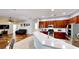 Spacious kitchen with stainless steel appliances, custom wood cabinets and a breakfast bar overlooking the living area at 1855 Sugar Cove Ct, Ocoee, FL 34761