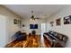 Spacious living room with hardwood floors, a ceiling fan, and an entertainment center at 1855 Sugar Cove Ct, Ocoee, FL 34761