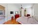 Main bedroom with wood floors, ceiling fan, and a sliding glass door at 1855 Sugar Cove Ct, Ocoee, FL 34761