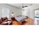 Main bedroom with hardwood floors, ceiling fan, and a reading nook at 1855 Sugar Cove Ct, Ocoee, FL 34761