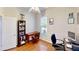 Office featuring hardwood floors, a desk, bookshelves, and a comfortable chair at 1855 Sugar Cove Ct, Ocoee, FL 34761