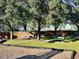 Park benches shaded by mature trees create a relaxing outdoor space at 1855 Sugar Cove Ct, Ocoee, FL 34761