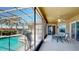 Relaxing screened-in patio with a pool view, ceiling fan, and outdoor dining area at 1855 Sugar Cove Ct, Ocoee, FL 34761