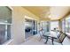 Inviting covered patio has comfortable seating and offers serene views through sliding glass doors at 1855 Sugar Cove Ct, Ocoee, FL 34761