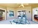 Relaxing covered patio has a glass table with seating and offers seamless indoor-outdoor living at 1855 Sugar Cove Ct, Ocoee, FL 34761