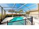Sparkling private pool with screened enclosure, safety fence, and comfortable lounge chairs at 1855 Sugar Cove Ct, Ocoee, FL 34761