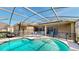 Sparkling pool with a safety fence and screened-in enclosure, set against the home's exterior at 1855 Sugar Cove Ct, Ocoee, FL 34761