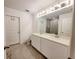 Double vanity bathroom with large mirror and toilet at 2058 Derwent Dr, Davenport, FL 33896
