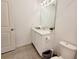 Bathroom with toilet, sink, and vanity with mirror at 2058 Derwent Dr, Davenport, FL 33896