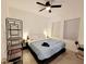 Bedroom with a king-size bed, ceiling fan, and a tall shelf at 2058 Derwent Dr, Davenport, FL 33896