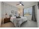 Cozy bedroom with chevron-patterned wall, a comfortable bed, and ample natural light at 2128 Silver Brook Way, Davenport, FL 33837